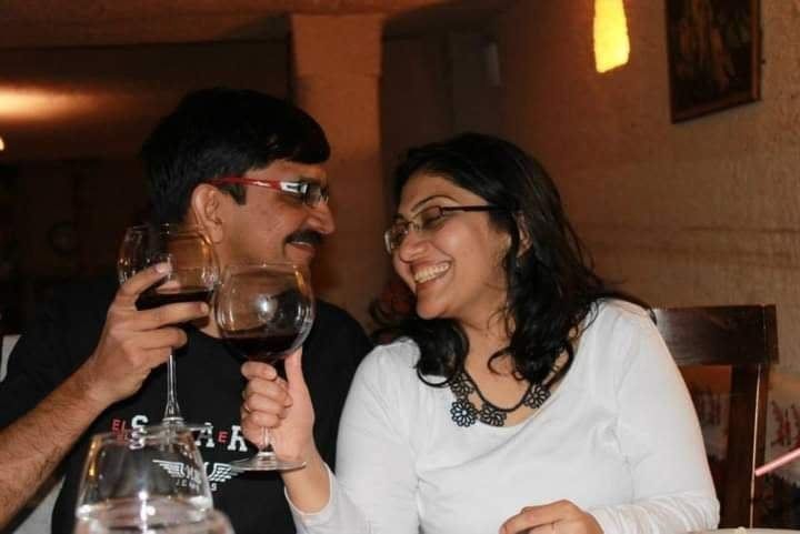 Bipin and his wife smiling at a dinner table